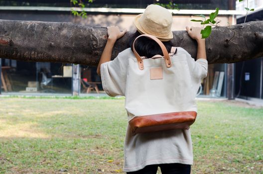 Young woman  holding banyan branch with a canvas bag, Outdoor portrait