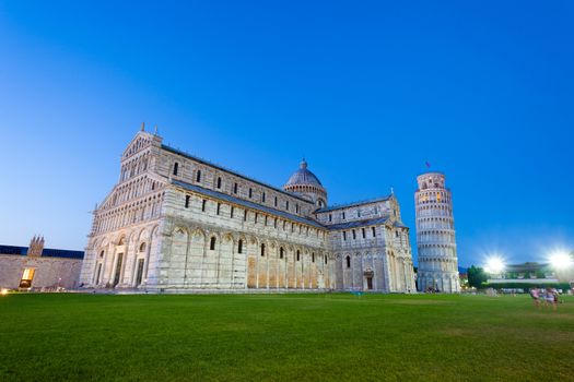 Pisa, Italy - August 11, 2013: Piazza del Duomo with Pisa tower and the Cathedral illuminated at night, Pisa, Italy
