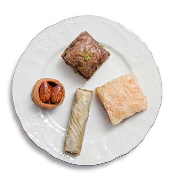 Plate with various turkish baklava isolated over white background