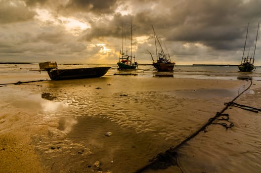 Fishing sea boat and Sunrise clouds before strom in Thailand gold light tone