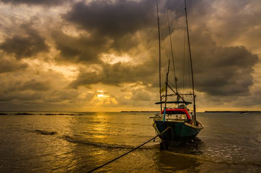 Fishing sea boat and Sunrise clouds before strom in Thailand gold light tone