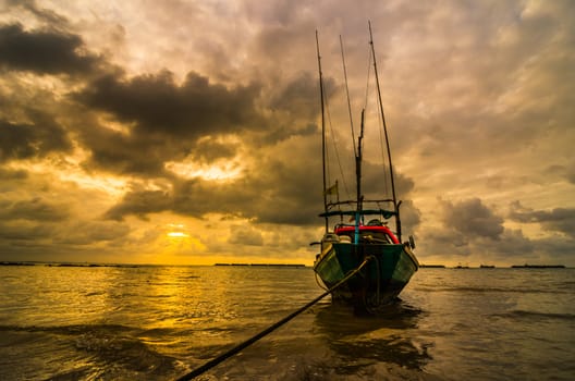 Fishing sea boat and Sunrise clouds before strom in Thailand gold light tone