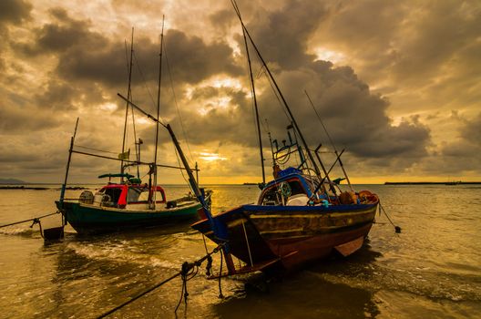 Fishing sea boat and Sunrise clouds before strom in Thailand gold light tone