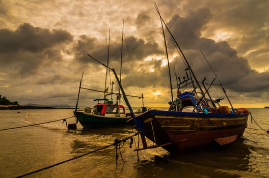 Fishing sea boat and Sunrise clouds before strom in Thailand gold light tone