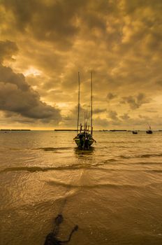 Fishing sea boat and Sunrise clouds before strom in Thailand gold light tone