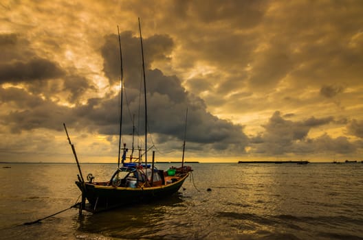 Fishing sea boat and Sunrise clouds before strom in Thailand gold light tone