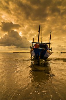 Fishing sea boat and Sunrise clouds before strom in Thailand gold light tone