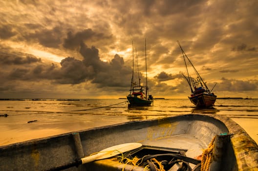 Fishing sea boat and Sunrise clouds before strom in Thailand gold light tone