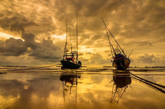 Fishing sea boat and Sunrise clouds before strom in Thailand gold light tone