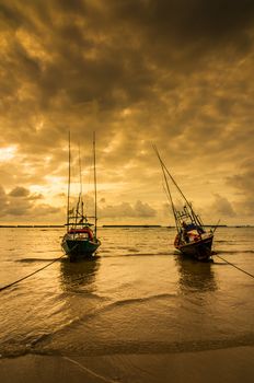 Fishing sea boat and Sunrise clouds before strom in Thailand gold light tone