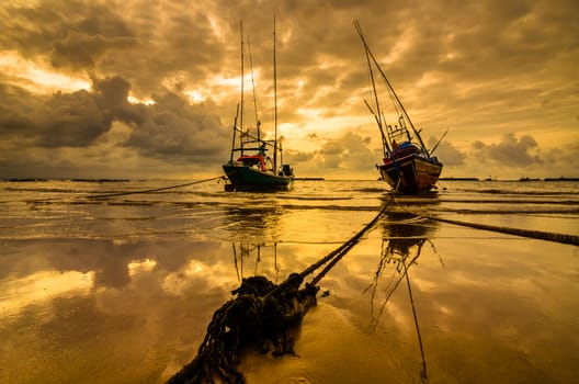 Fishing sea boat and Sunrise clouds before strom in Thailand gold light tone