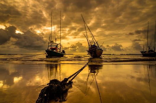 Fishing sea boat and Sunrise clouds before strom in Thailand gold light tone