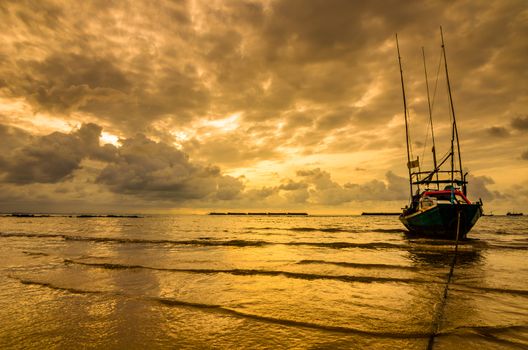 Fishing sea boat and Sunrise clouds before strom in Thailand gold light tone