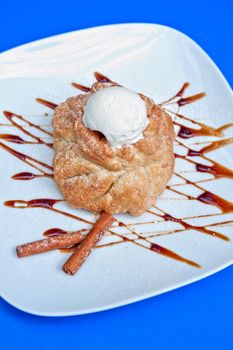 apple strudel with ice cream at blue background