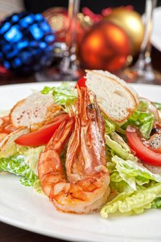 Tasty shrimp salad with vegetables on christmas table