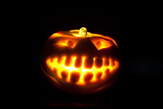 Halloween pumpkin with scary face on black backgound