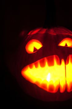 Halloween pumpkin with scary face on black backgound