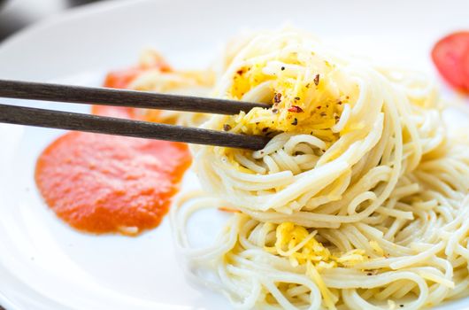 spaghetti dinner with sauce and basil close up