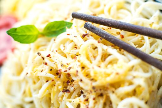 spaghetti dinner with chopsticks close up