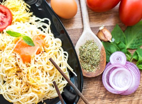 spaghetti dinner with sauce and basil close up