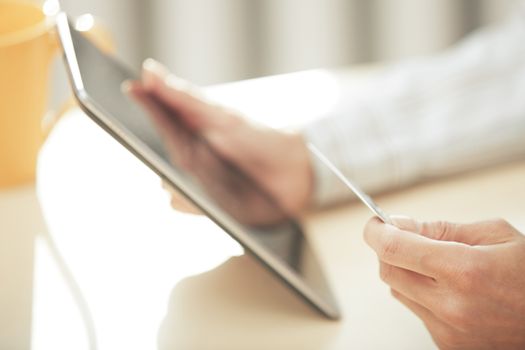 Hands of woman with credit card and digital PC