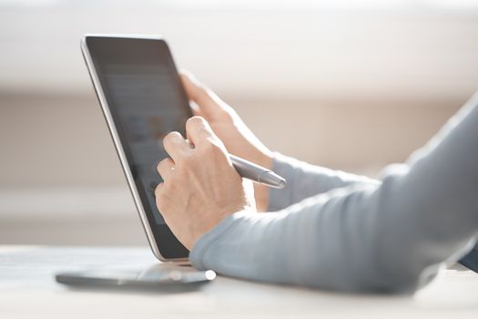 Human hands using tablet PC for Internet surfing