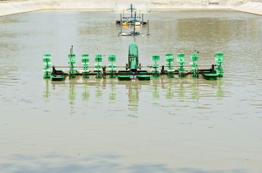 Pump adding oxygen to the water for wastewater treatment in small factories.
