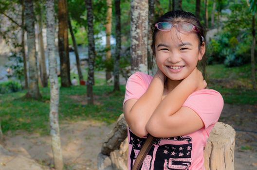 Young girl smiled happily with hiking and camping in the forest