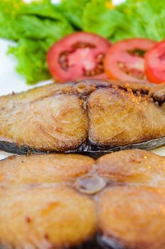 Piece fish meat of King Mackerel fried doused with sauce