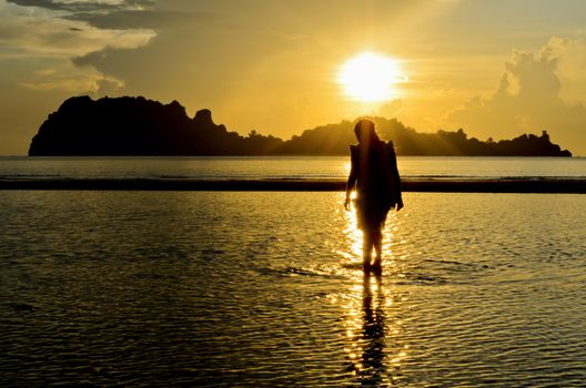 Girls on the Hat Sai Ri beach during sunrise in Chumphon Province of Thailand