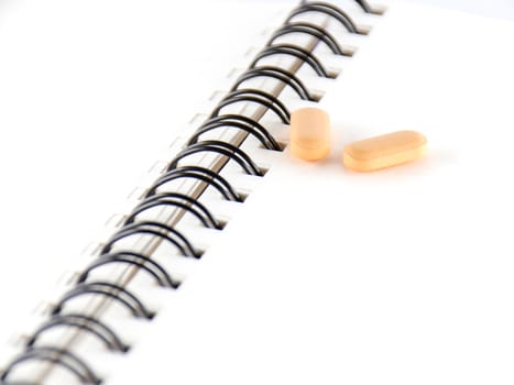 two pills on notebook concept seriousness