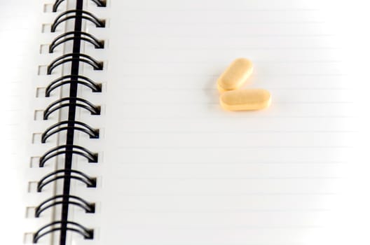 two pills on notebook concept seriousness