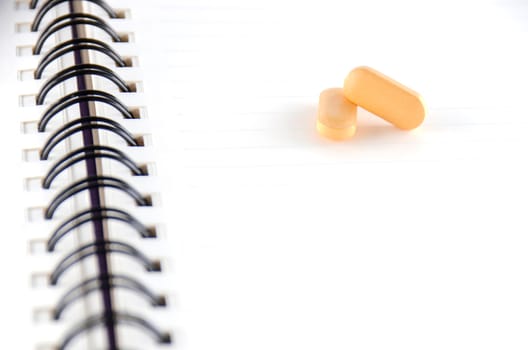 two pills on notebook concept seriousness