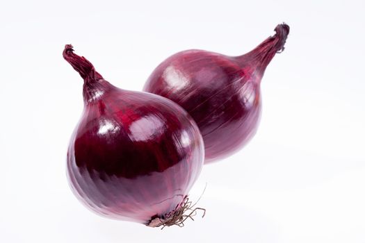 two red onions isolated on white background closeup