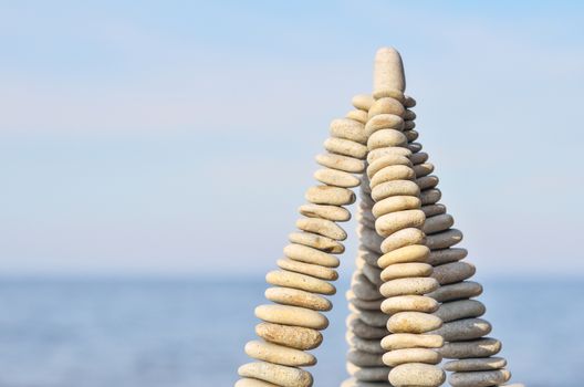 Pyramidal group of small pebbles in the balance on the seashore