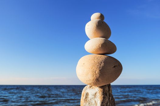 Balancing of white pebbles each other on the seacoast