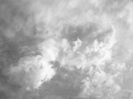 Soft black and white clouds against sky .