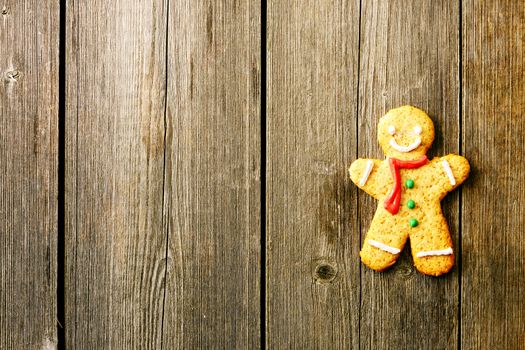 Christmas homemade gingerbread man over wooden table