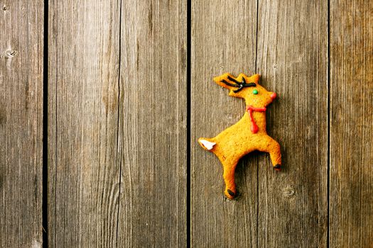 Christmas homemade gingerbread deer over wooden table