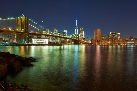 Brooklyn Bridge with lower Manhattan skyline in New York City at night