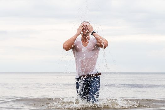 Sport, fitness. Bodybuilder standing in the water