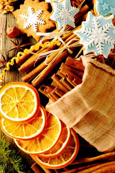 Christmas homemade gingerbread cookie and spices over wooden table