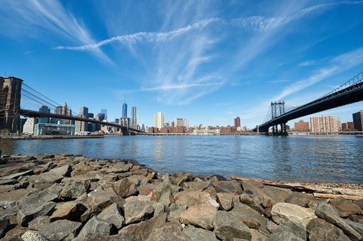 Manhattan skyline view from Brooklyn between Brooklyn Bridge and Manhattan Bridge in New York City