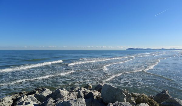 Relaxing and beautiful view of Adriatic seaside from Rimini in a sunny day with blue sky and clean sea with waves, Italy, Europe.