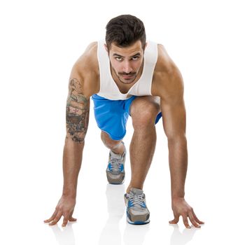 Athletic man ready to start running, isolated over a white background