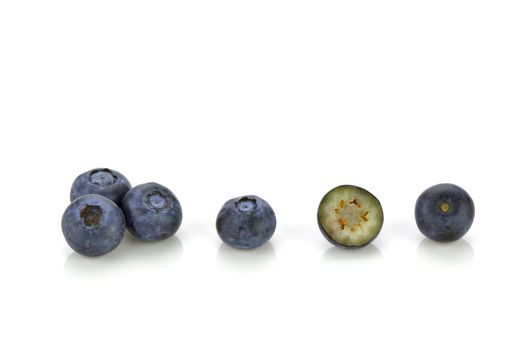 Close-up of several blueberries, one is cut in half