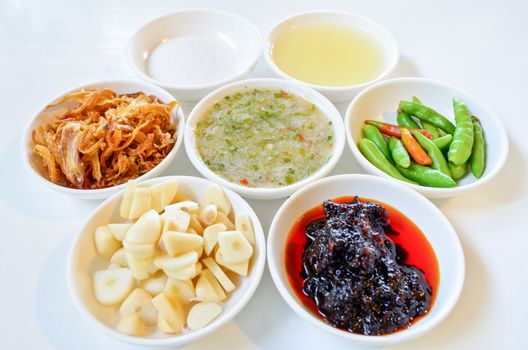 Thai food condiment in a separate small cups.