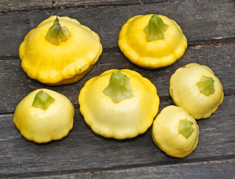 Yellow Patissons on a wooden table