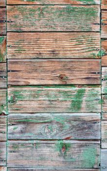 Texture of wall made of planks with paint peeling off