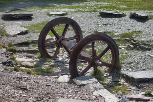 a pair of old disused metal mine train wheels